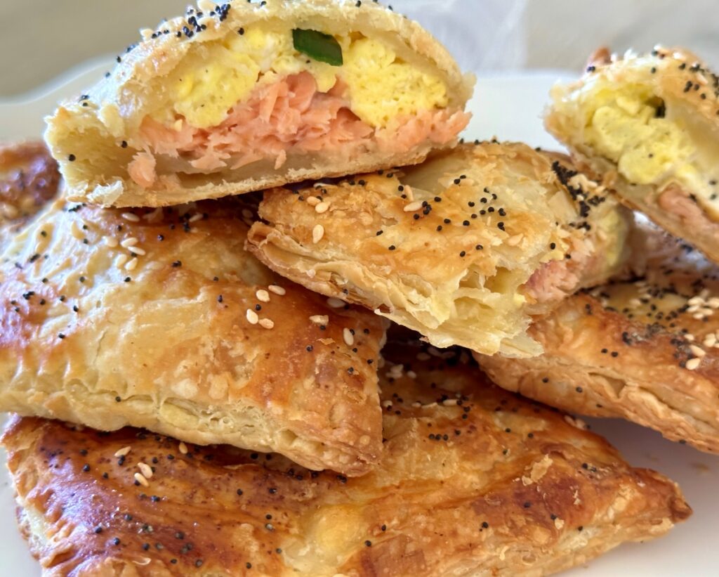 Breakfast Salmon Wellington, Salmon en Croute Pastry, is a warm, flaky, handheld with egg, goat cheese, & scallions wrapped in puff pastry.