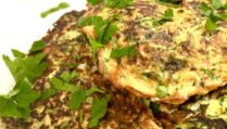 Zucchini and Feta fritters on a serving platter with parsley