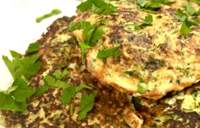 Zucchini and Feta fritters on a serving platter with parsley